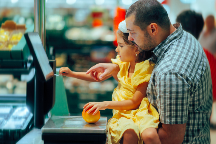 Family in a store checking the fruits measuring weight